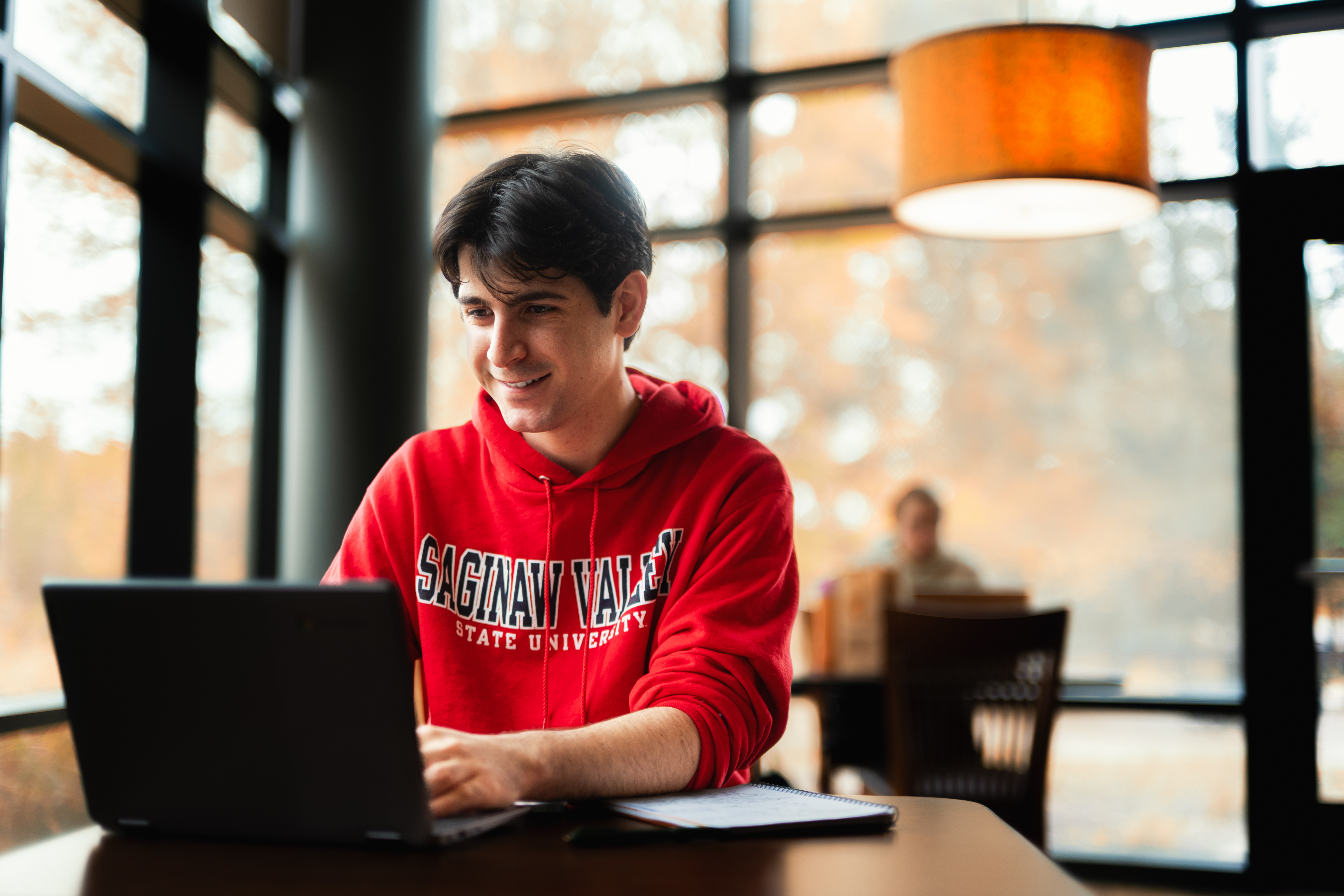 Student at table with laptop